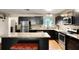 Modern kitchen featuring stainless steel appliances, granite countertops, and dark cabinets for a sleek design at 25824 Shawnee St, Sorrento, FL 32776