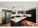 Well-equipped kitchen with stainless steel appliances, granite countertops, and a stylish island with seating at 25824 Shawnee St, Sorrento, FL 32776