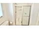 Clean bathroom with a glass shower featuring a seat, a toilet and neutral walls at 2585 Karen Dr, Mount Dora, FL 32757