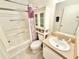 Functional bathroom featuring a shower-tub combo, vanity with sink, and ample storage space at 2585 Karen Dr, Mount Dora, FL 32757