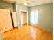 Bright bedroom featuring light green walls, natural light, closet with ample storage space and wood flooring at 2585 Karen Dr, Mount Dora, FL 32757