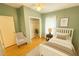 Comfortable bedroom featuring light green walls, ceiling fan, and closet with ample storage space at 2585 Karen Dr, Mount Dora, FL 32757