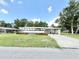 Charming single-story home with well-maintained lawn, a driveway and mature trees at 2585 Karen Dr, Mount Dora, FL 32757