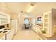 Eat-in kitchen boasts white appliances, island, and a view to the dining area at 2585 Karen Dr, Mount Dora, FL 32757
