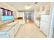 Well-lit kitchen with white cabinetry, tiled floors, and modern appliances at 2585 Karen Dr, Mount Dora, FL 32757