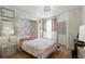 Cozy bedroom featuring a Murphy bed, stylish floral wallpaper, and light wood flooring at 2639 Maitland Crossing Way # 102, Orlando, FL 32810