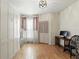 Bedroom with light wood floors, white walls, and a desk at 2639 Maitland Crossing Way # 102, Orlando, FL 32810
