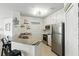 A well-lit kitchen with stainless steel appliances and stylish decor, perfect for modern living at 2639 Maitland Crossing Way # 102, Orlando, FL 32810