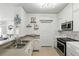 Kitchen featuring white cabinets, stainless steel appliances, and ample countertop space at 2639 Maitland Crossing Way # 102, Orlando, FL 32810