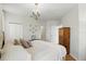 Bedroom featuring a cozy bed, wood floors, and a chandelier at 2639 Maitland Crossing Way # 102, Orlando, FL 32810