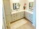 Bright bathroom featuring custom cabinets, dual sinks, and matching mirrors and decor at 2648 Maymont Ct, The Villages, FL 32163