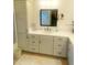 Bathroom featuring custom cabinets, dual sinks, and matching mirrors and decor at 2648 Maymont Ct, The Villages, FL 32163