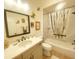 Bright bathroom featuring a shower-tub combo and a vanity with granite countertop at 2648 Maymont Ct, The Villages, FL 32163