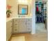 Bathroom vanity area leads to a walk-in closet for easy storage and access at 2648 Maymont Ct, The Villages, FL 32163