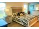 Comfortable bedroom with a warm lamp, a soft quilt, and decorative nautical accents at 2648 Maymont Ct, The Villages, FL 32163