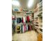 Spacious walk-in closet with custom shelving and organized storage solutions for clothing and accessories at 2648 Maymont Ct, The Villages, FL 32163