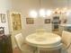 Cozy dining area with a round table and decorative hutch, flooded with natural light at 2648 Maymont Ct, The Villages, FL 32163