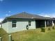 Backyard view of home with covered patio and grassy lawn at 2648 Maymont Ct, The Villages, FL 32163