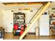 Well-lit garage with ample storage, pegboard wall and pull-down attic access ladder at 2648 Maymont Ct, The Villages, FL 32163