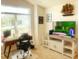 Comfortable home office with large window, desk, and wall-mounted television at 2648 Maymont Ct, The Villages, FL 32163