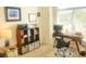 Bright home office with desk, shelving unit, and natural light from large windows at 2648 Maymont Ct, The Villages, FL 32163