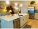 Open concept kitchen with island, stainless steel appliances and view to living area at 2648 Maymont Ct, The Villages, FL 32163