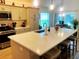 Well-lit kitchen island with quartz counters and stainless-steel appliances at 2648 Maymont Ct, The Villages, FL 32163