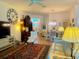 Cozy living room with stylish furnishings, a large clock, and an open layout perfect for entertaining at 2648 Maymont Ct, The Villages, FL 32163