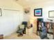 Cozy home office featuring a comfortable chair, ample lighting, and decorative artwork at 2648 Maymont Ct, The Villages, FL 32163