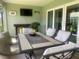 Cozy screened-in dining space with seating for six, a TV, and nice backyard views at 2648 Maymont Ct, The Villages, FL 32163