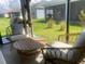 Inviting screened porch with comfortable seating, perfect for relaxing and enjoying the outdoors at 2648 Maymont Ct, The Villages, FL 32163