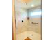 Modern shower featuring marble-patterned tiles, a frameless glass enclosure, and a built-in shelf at 2648 Maymont Ct, The Villages, FL 32163