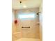 Bright tiled shower featuring a built-in shower bench and a hand rail at 2648 Maymont Ct, The Villages, FL 32163