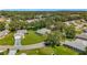 Aerial view of a neighborhood with well-kept lawns and large shade trees at 27141 Racquet Cir, Leesburg, FL 34748
