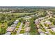 An aerial view reveals homes nestled in a peaceful 55+ community, with serene ponds and mature trees at 27141 Racquet Cir, Leesburg, FL 34748