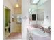 Bathroom featuring a single vanity with pink countertops and a separate toilet and shower room at 27141 Racquet Cir, Leesburg, FL 34748