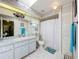 Bathroom with a patterned floor, and shower with tub and white curtain at 27141 Racquet Cir, Leesburg, FL 34748