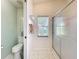 Bathroom featuring a shower, toilet, and a window with natural light at 27141 Racquet Cir, Leesburg, FL 34748