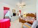 Bright bedroom featuring a wooden bed frame, dresser, ceiling fan, and natural light from the window at 27141 Racquet Cir, Leesburg, FL 34748