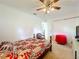 Bedroom with a wooden bed frame, ceiling fan, and neutral walls at 27141 Racquet Cir, Leesburg, FL 34748