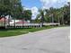 View of the community pool nestled among lush landscaping, offering a serene retreat for residents at 27141 Racquet Cir, Leesburg, FL 34748