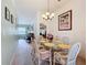 Open dining room with seating, lighting and view to other rooms at 27141 Racquet Cir, Leesburg, FL 34748