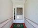 Covered front entryway featuring a decorative storm door and a festive Ohio State Buckeyes welcome mat at 27141 Racquet Cir, Leesburg, FL 34748
