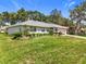 Charming single-story home with lush front lawn, mature landscaping, and a well-maintained exterior showcasing curb appeal at 27141 Racquet Cir, Leesburg, FL 34748