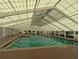Enjoy swimming year-round in this large, naturally-lit, indoor swimming pool with tiled floor and ceiling at 27141 Racquet Cir, Leesburg, FL 34748