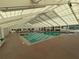 Large, naturally-lit, indoor swimming pool allows swimming year-round with a tiled floor at 27141 Racquet Cir, Leesburg, FL 34748