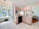 Open kitchen design with breakfast bar and view of the sink and cabinets at 27141 Racquet Cir, Leesburg, FL 34748