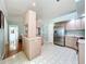 Spacious kitchen with stainless steel refrigerator and view of the breakfast bar at 27141 Racquet Cir, Leesburg, FL 34748