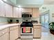 Kitchen with stainless steel appliances and natural light at 27141 Racquet Cir, Leesburg, FL 34748