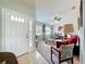 Inviting living room featuring a bright interior, neutral carpet, and a ceiling fan for added comfort at 27141 Racquet Cir, Leesburg, FL 34748